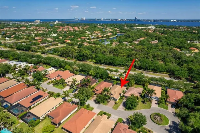 an aerial view of residential houses with outdoor space and trees