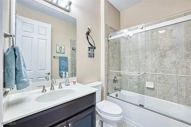 a bathroom with a double vanity sink toilet and shower