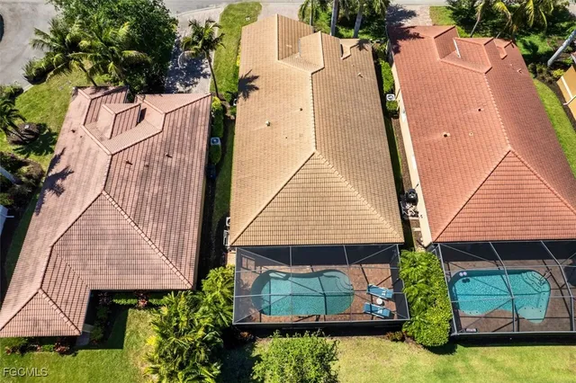 an aerial view of a house with a yard and potted plants