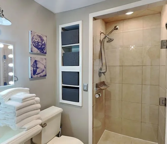 a bathroom with a shower toilet and a shower