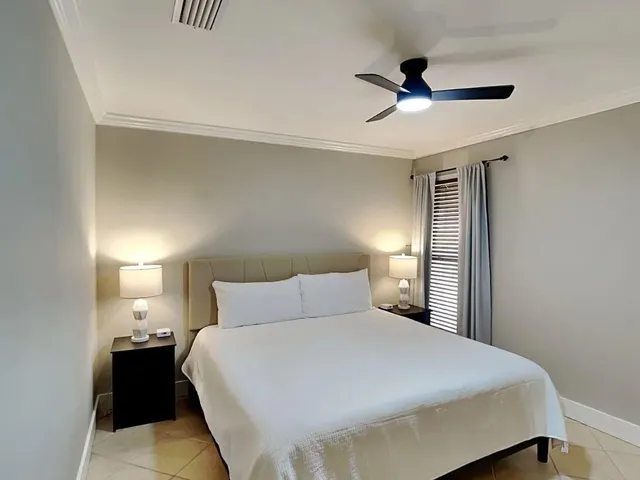 a bedroom with a bed and a ceiling fan