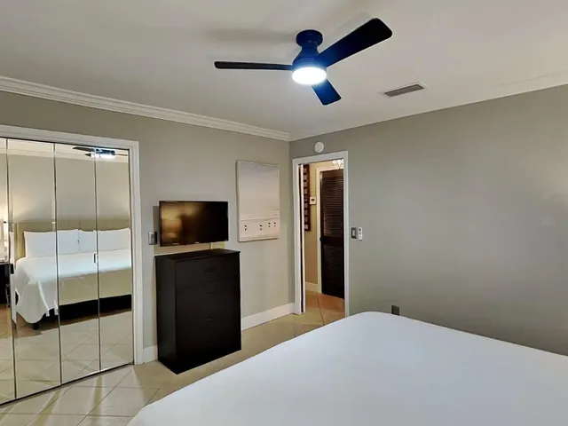 a bedroom with a bed and a television