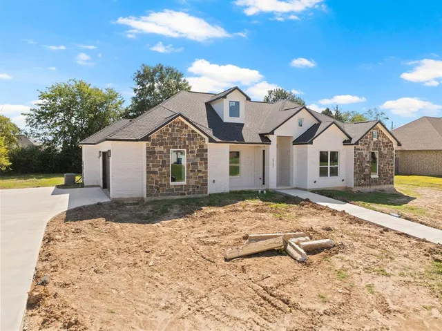 a view of a white house with a yard