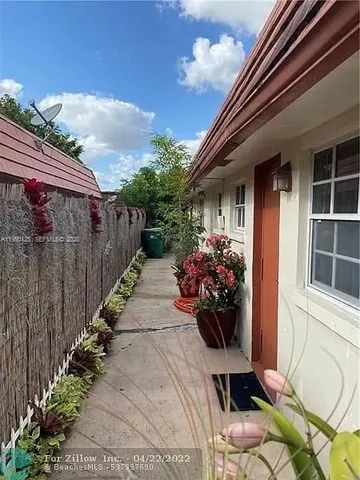 a view of a backyard with plants and a garden