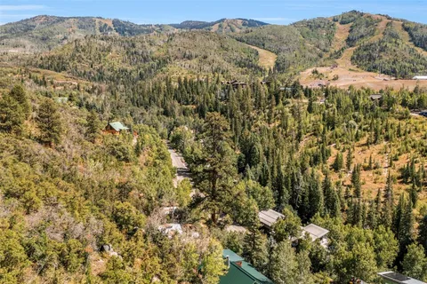 a view of a dry yard with mountains in the background