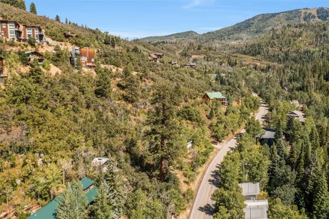 a view of a houses with a lush green hillside