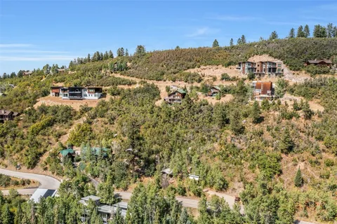 an aerial view of residential houses with city view