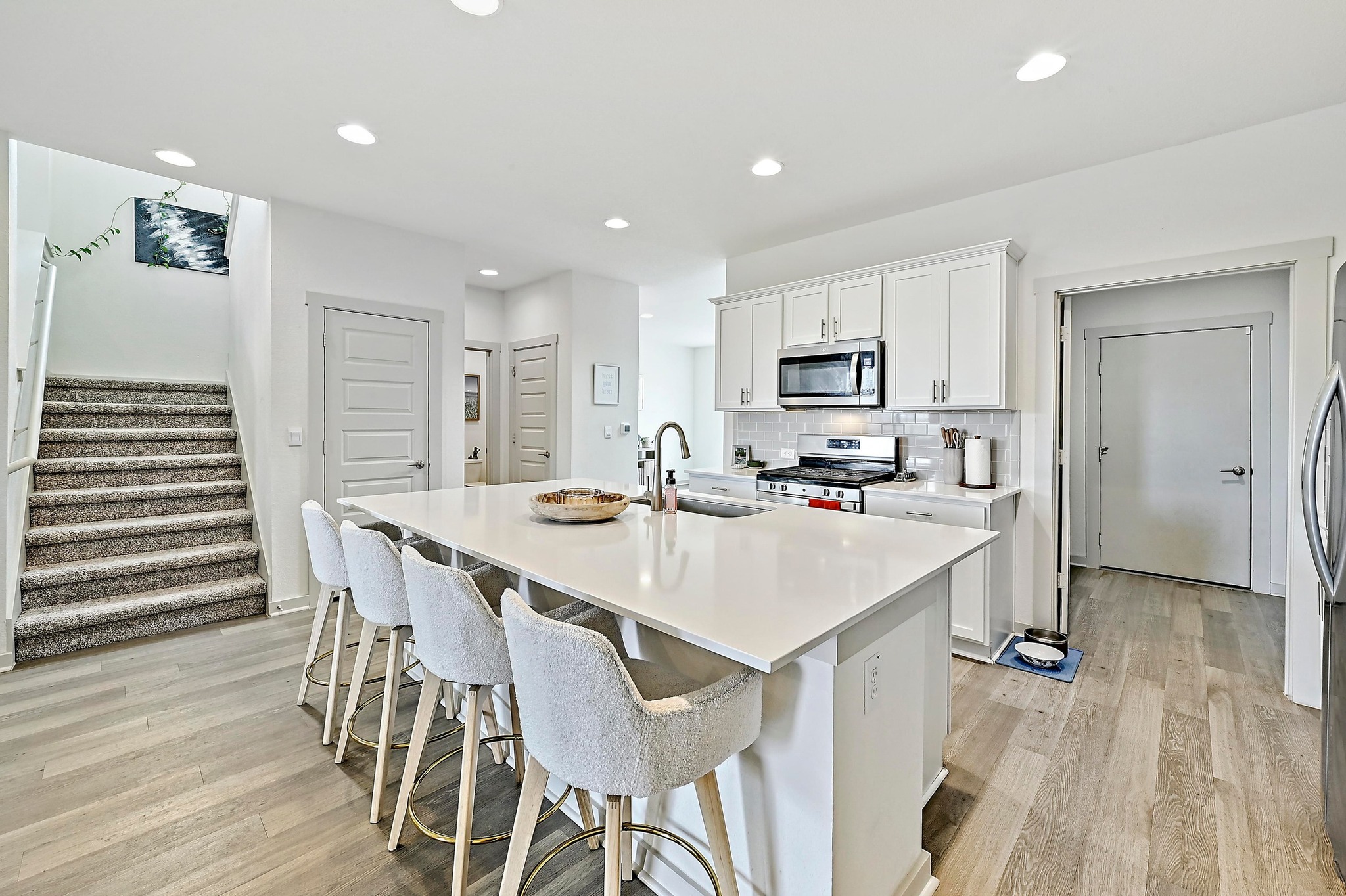 7712 Linnie Lane Austin, TX 78724 - Photo 12 of 37 a kitchen with a sink a microwave and refrigerator