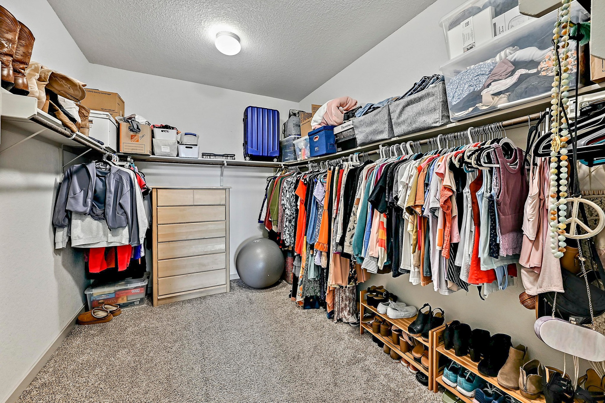 7712 Linnie Lane Austin, TX 78724 - Photo 19 of 37 a view of walk in closet with clothes and shoes