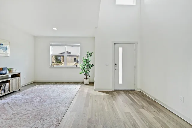 an empty room with windows and closet