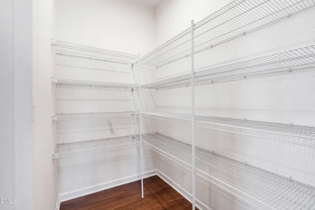 a kitchen with stainless steel appliances granite countertop a refrigerator a stove and a sink with wooden floor