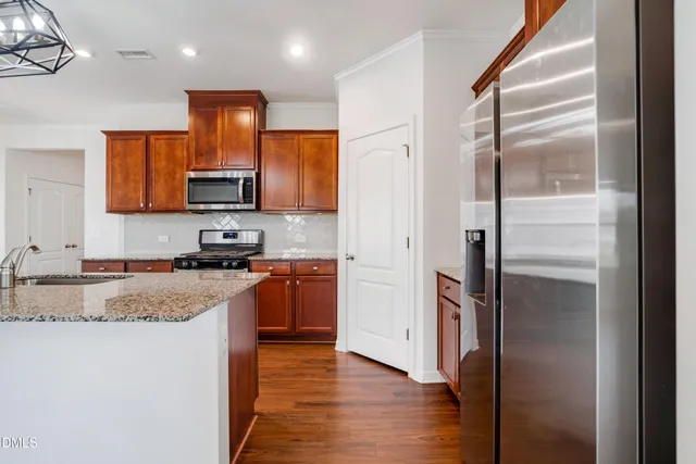 a view of empty room with wooden floor and window