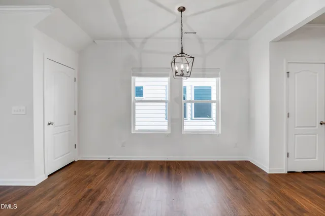 a view of hallway with wooden floor