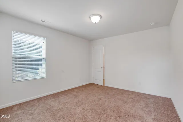 an aerial view of a house with garden space and street view