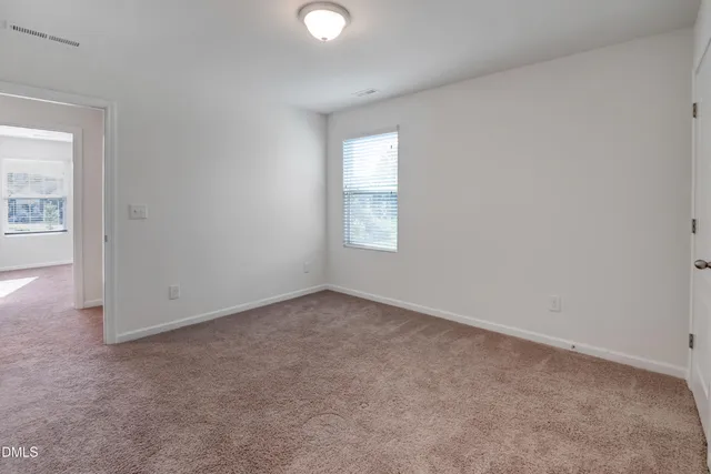 an aerial view of a house with a yard and lake view