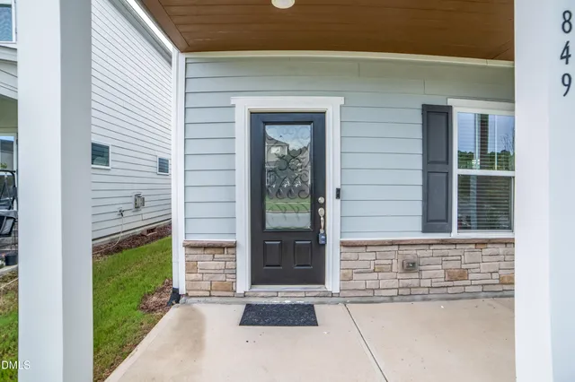 a view of a porch with wooden floor and iron stairs