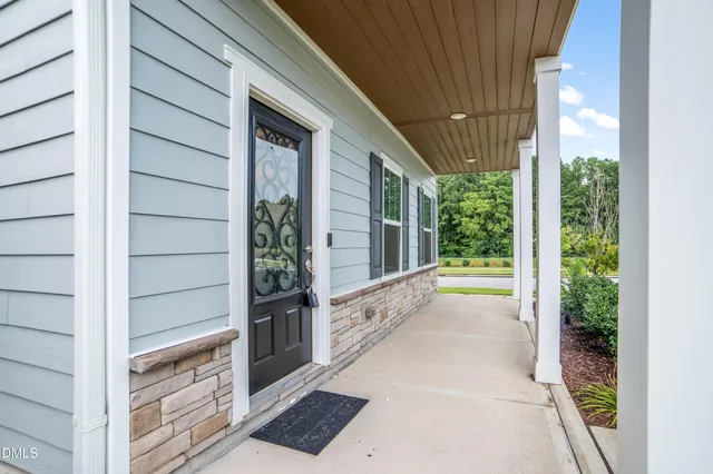 a view of a porch with a wooden door and deck
