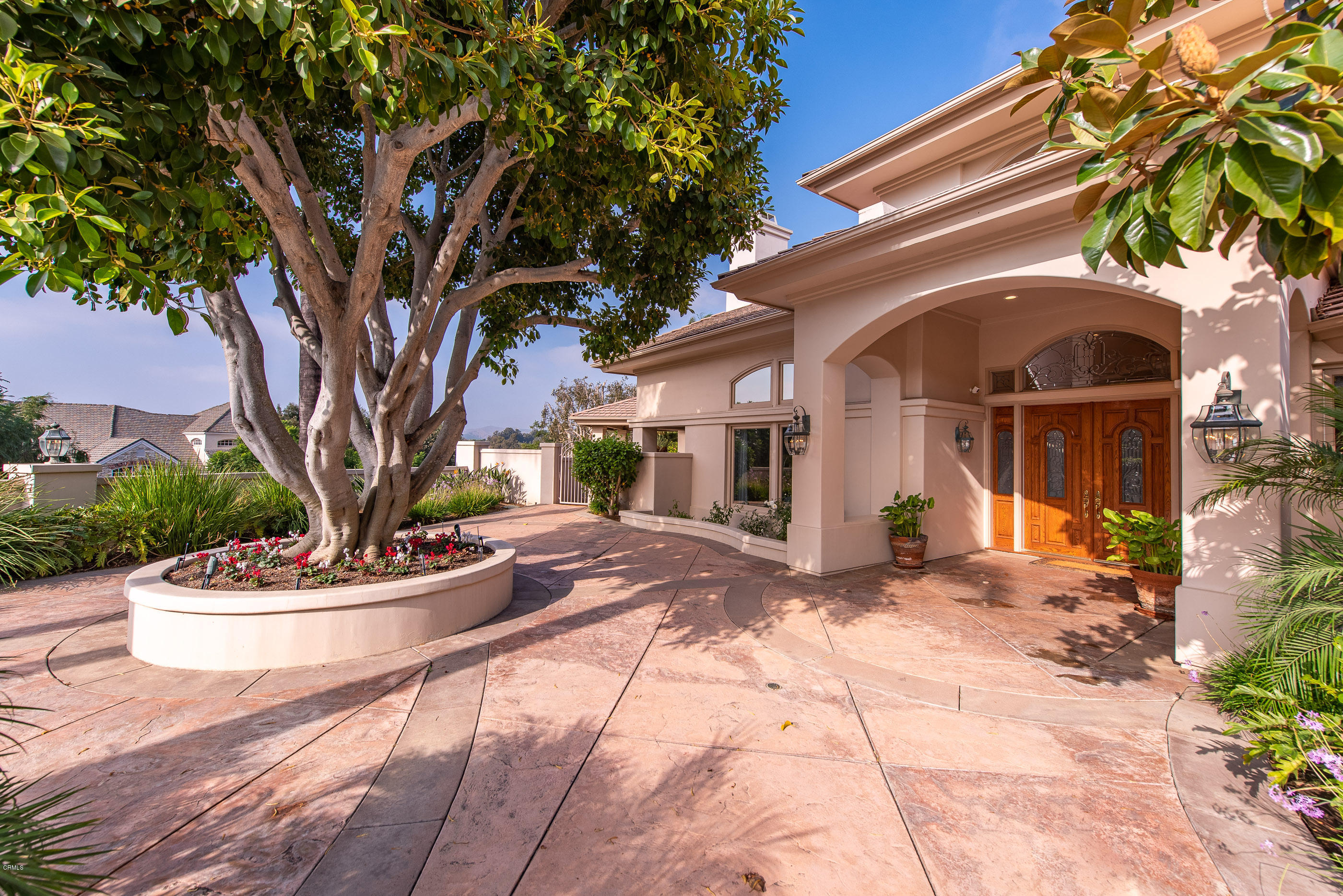657 Corte Corrida Camarillo, CA 93010 - Photo 13 of 74 a view of a white house with a large tree and potted plants