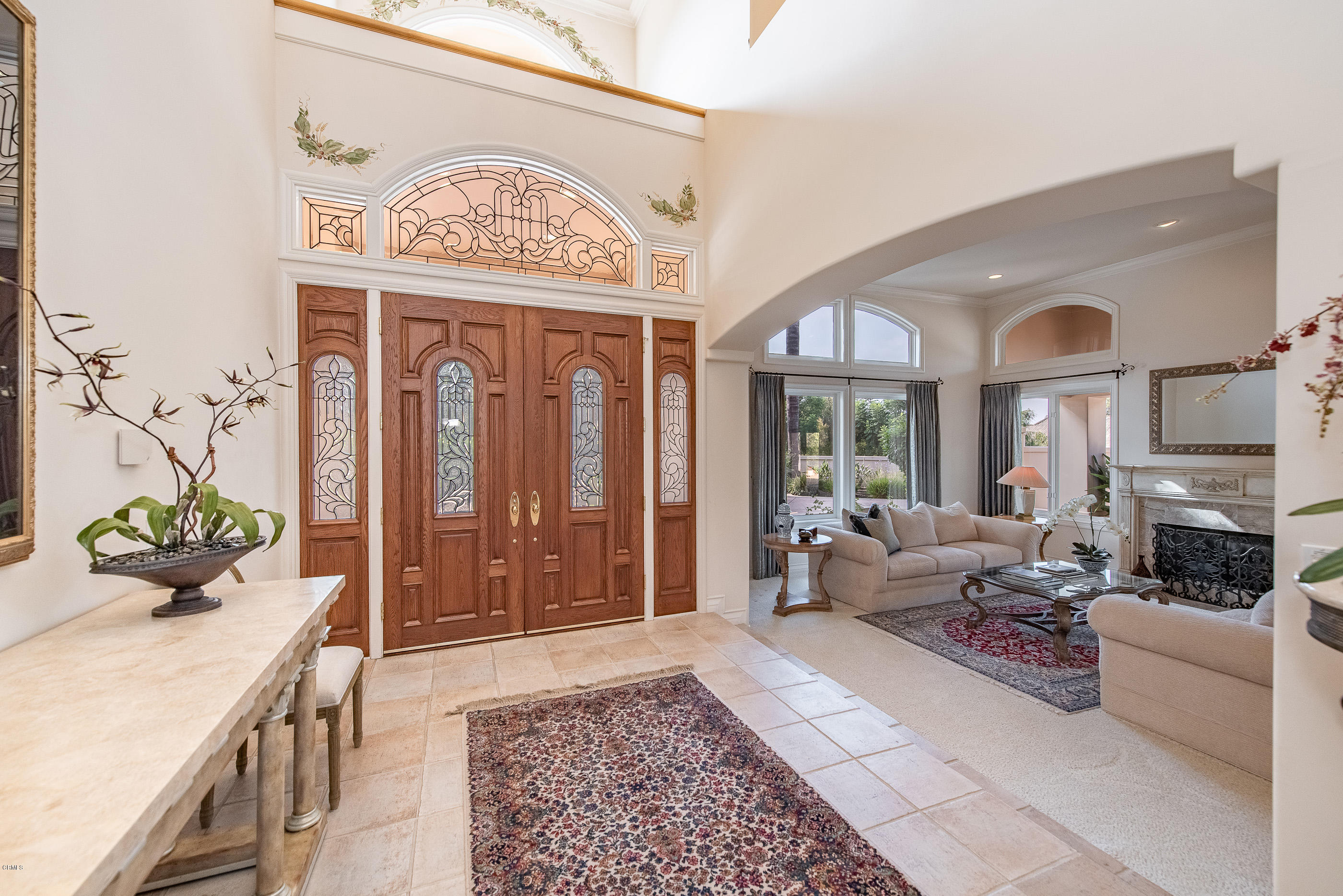 657 Corte Corrida Camarillo, CA 93010 - Photo 17 of 74 a living room with furniture a fireplace and a chandelier