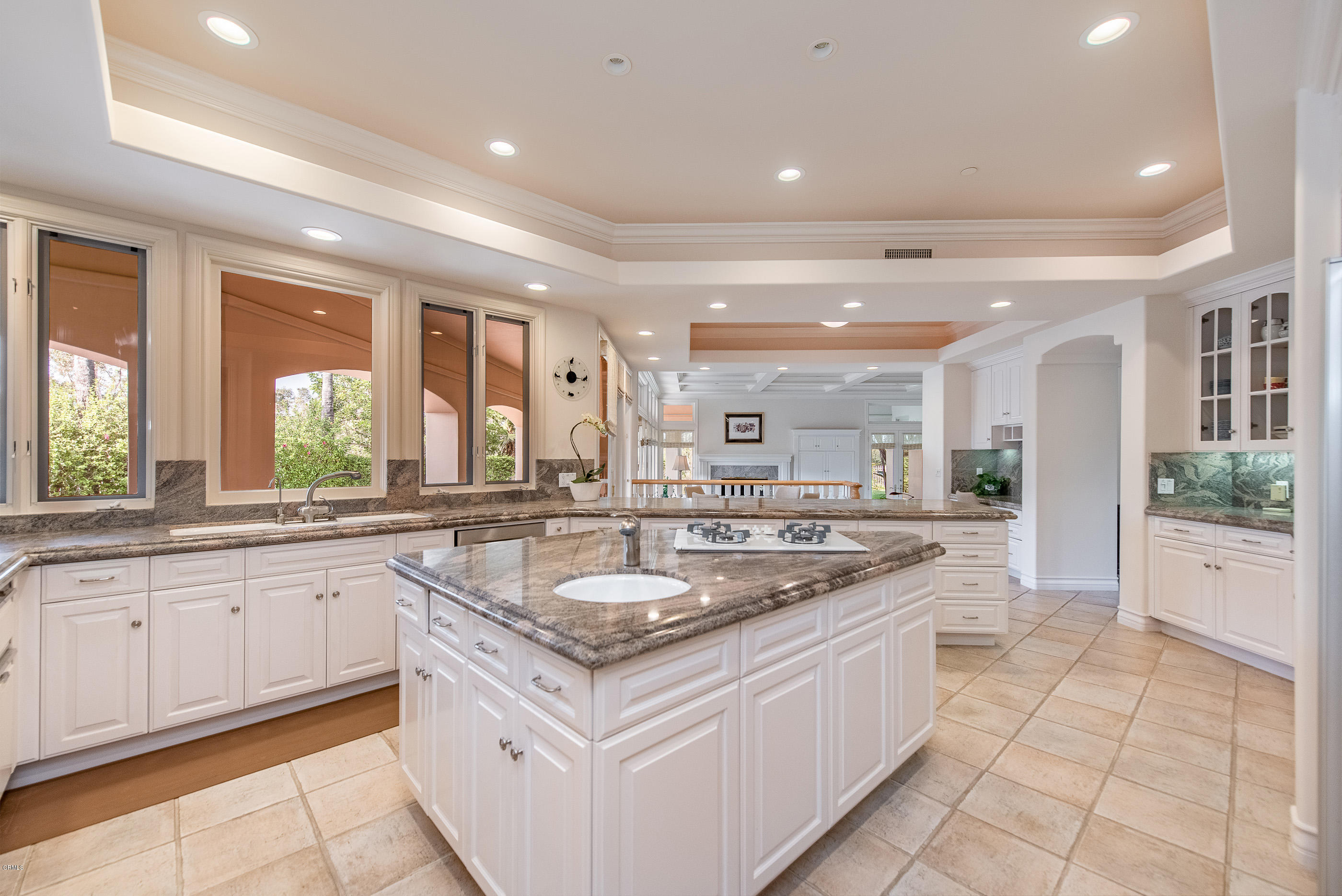 657 Corte Corrida Camarillo, CA 93010 - Photo 22 of 74 a kitchen with granite countertop a sink and white cabinets