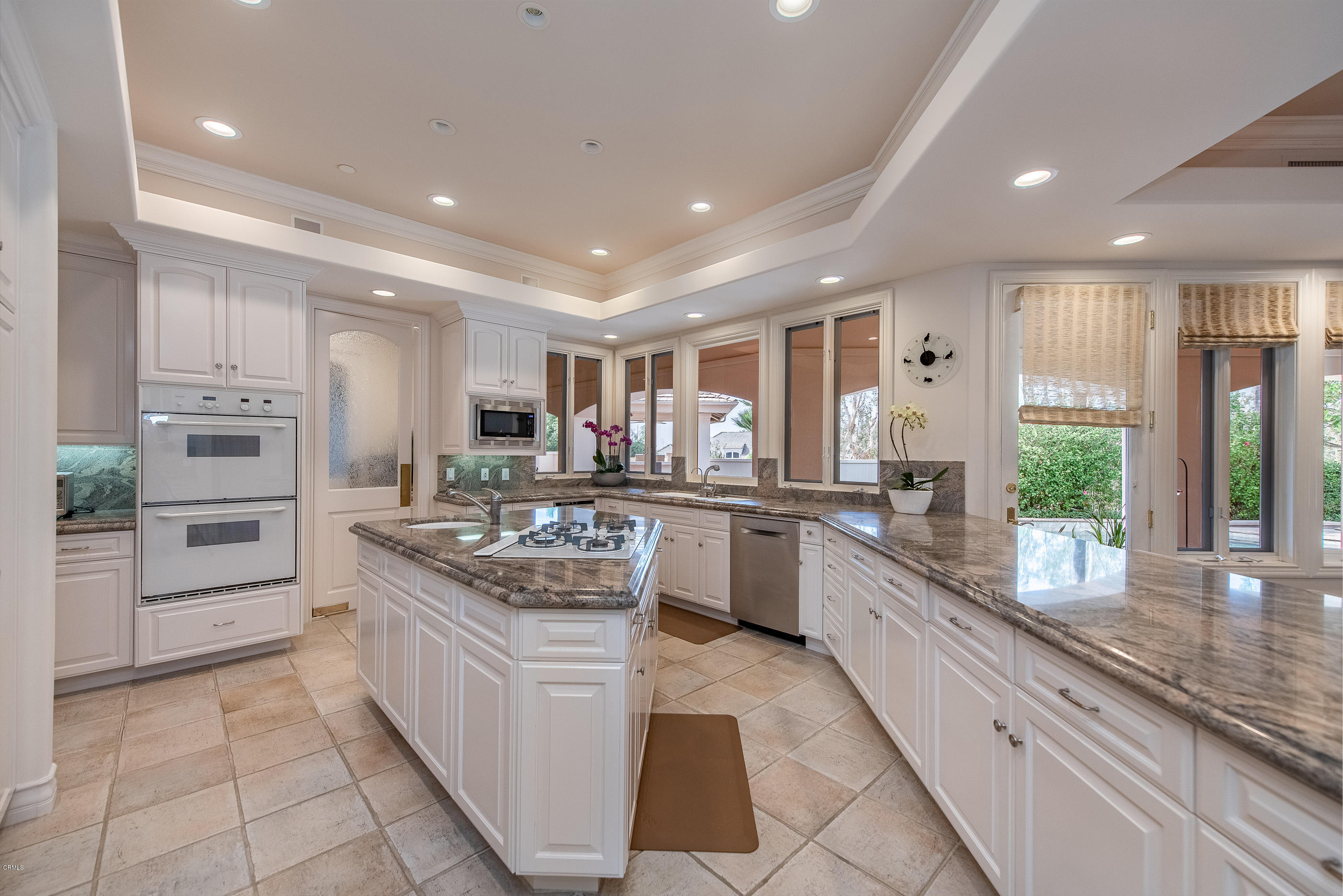 657 Corte Corrida Camarillo, CA 93010 - Photo 23 of 74 a kitchen with white cabinets and appliances