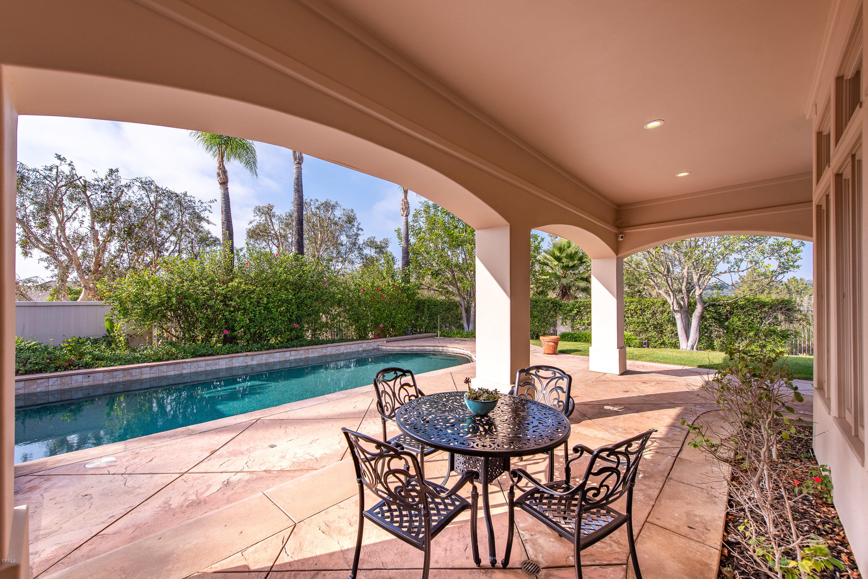 657 Corte Corrida Camarillo, CA 93010 - Photo 47 of 74 a view of a patio with a table chairs and a floor to ceiling window