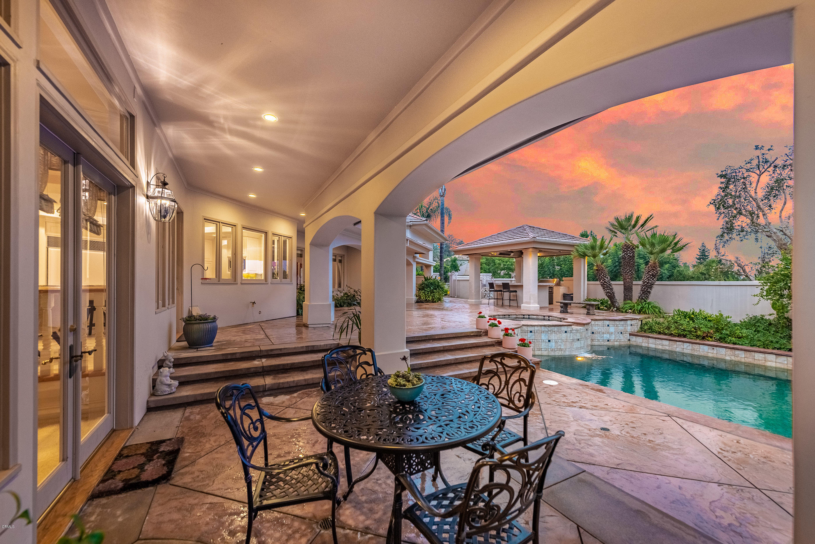 657 Corte Corrida Camarillo, CA 93010 - Photo 61 of 74 a patio with table and chairs and couches with wooden floor and lake view