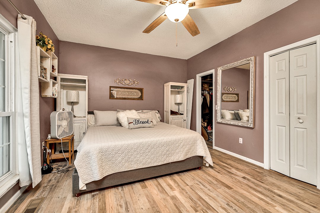 624 Faith-Rae Boulevard Morrison, TN 37357 - Photo 19 of 38 a bedroom with a large bed and a chandelier