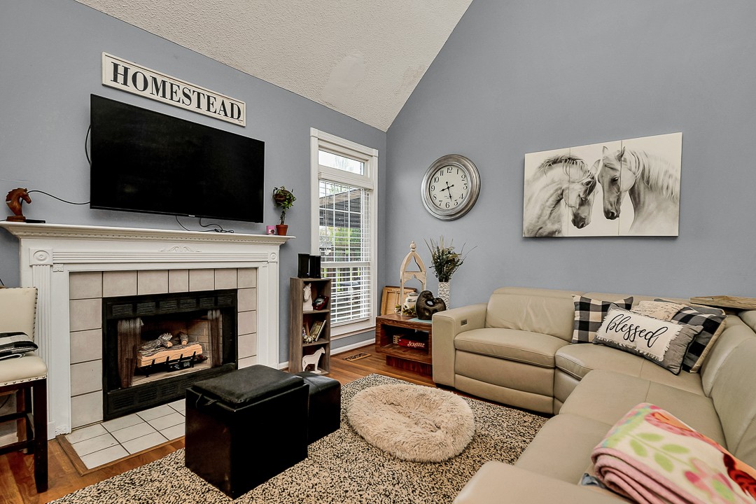 624 Faith-Rae Boulevard Morrison, TN 37357 - Photo 6 of 38 a living room with furniture a flat screen tv and a fireplace