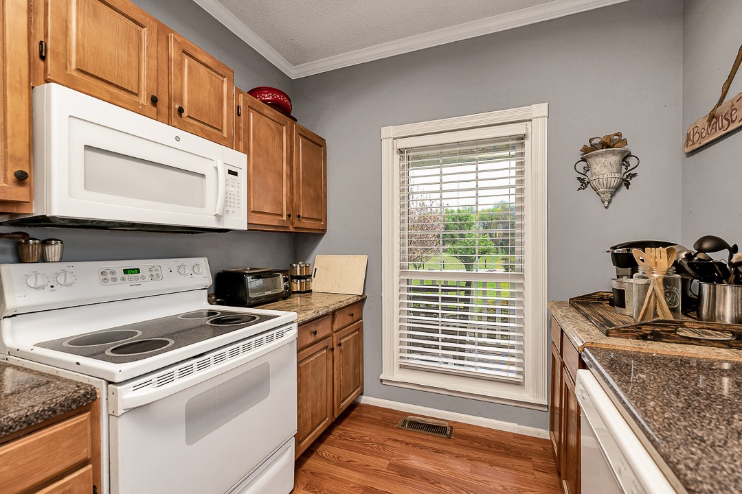 624 Faith-Rae Boulevard Morrison, TN 37357 - Photo 10 of 38 a kitchen with stainless steel appliances granite countertop a stove a sink and a microwave