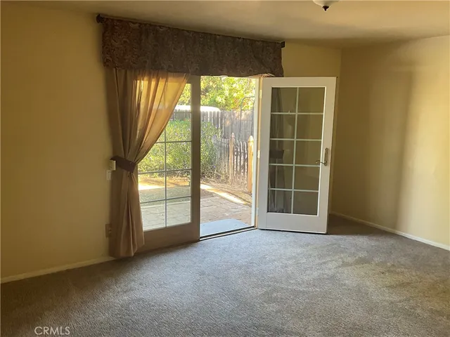 an empty room with a large window and doors