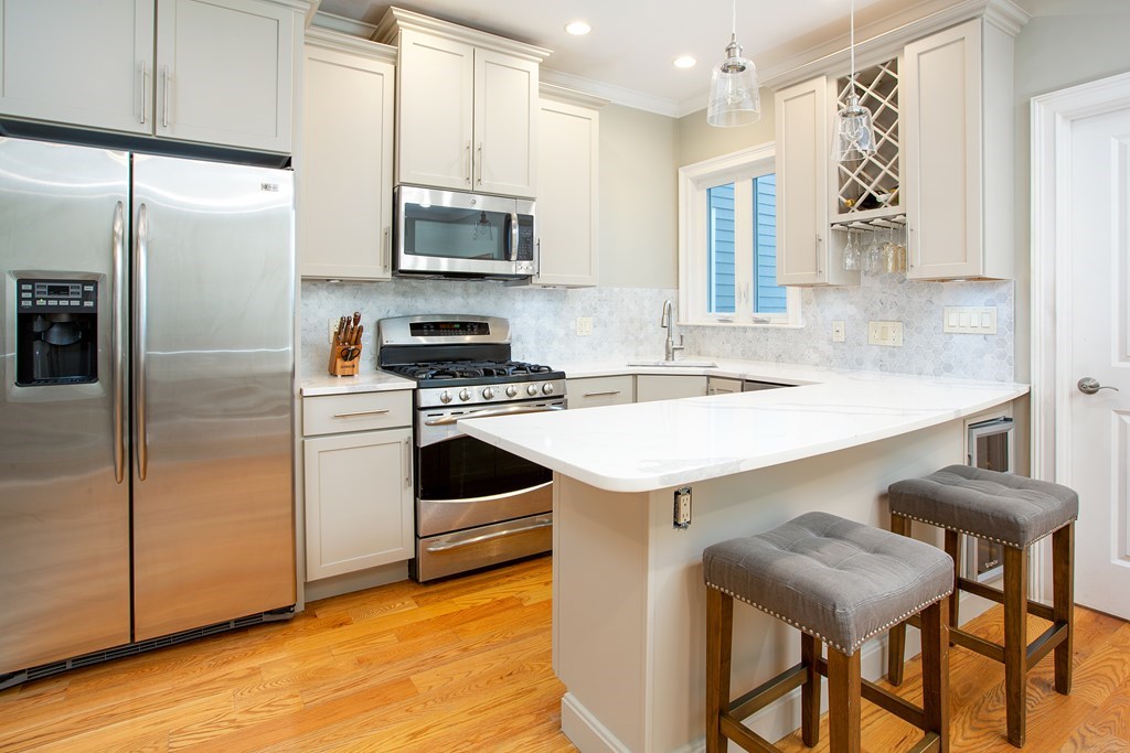 a kitchen with a sink appliances and cabinets
