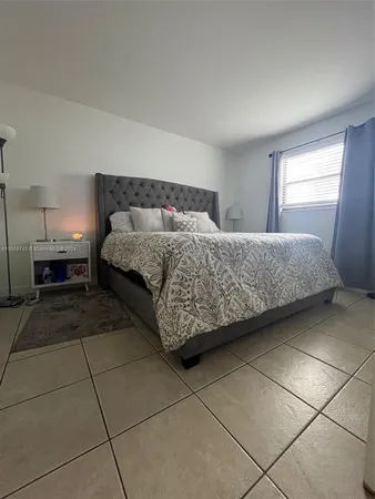 a bathroom with a granite countertop sink a toilet and a shower