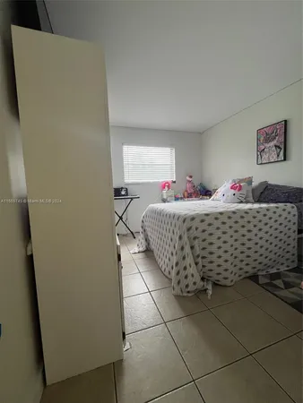 a spacious bedroom with a bed and a window in it