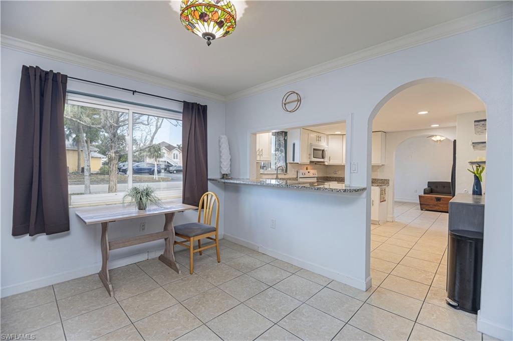 1003 Trail Terrace Drive Naples, FL 34103 - Photo 15 of 23 a living room with furniture and a large window