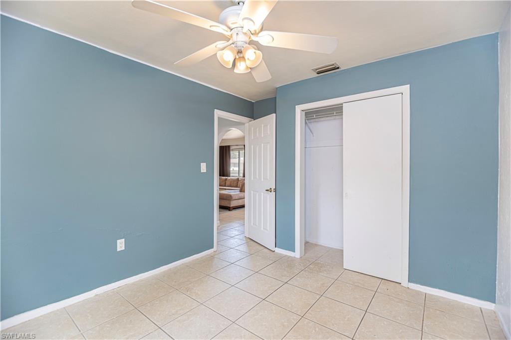 1003 Trail Terrace Drive Naples, FL 34103 - Photo 20 of 23 a view of an empty room with a chandelier fan