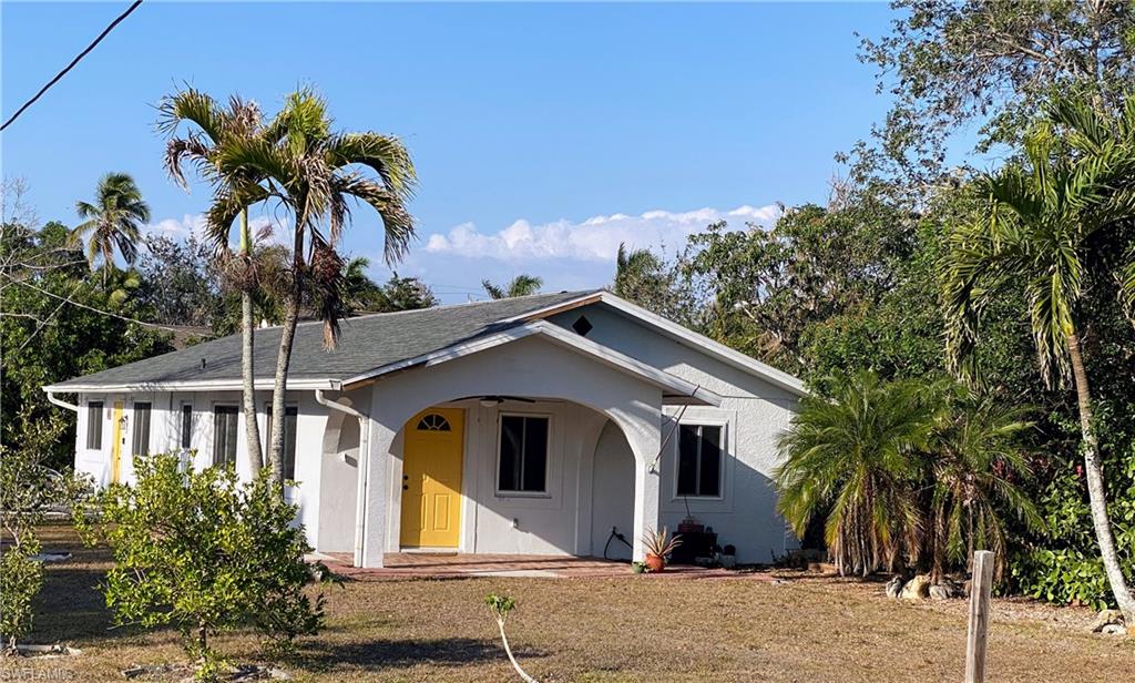 1003 Trail Terrace Drive Naples, FL 34103 - Photo 2 of 23 a front view of a house with a yard