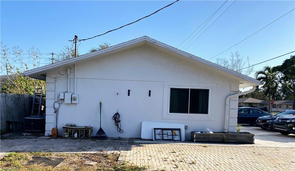 1003 Trail Terrace Drive Naples, FL 34103 - Photo 4 of 23 a front view of a house with a yard