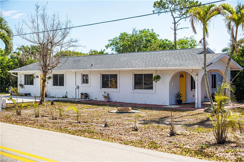 1003 Trail Terrace Drive Naples, FL 34103 - Photo 6 of 23 a front view of a house with garden