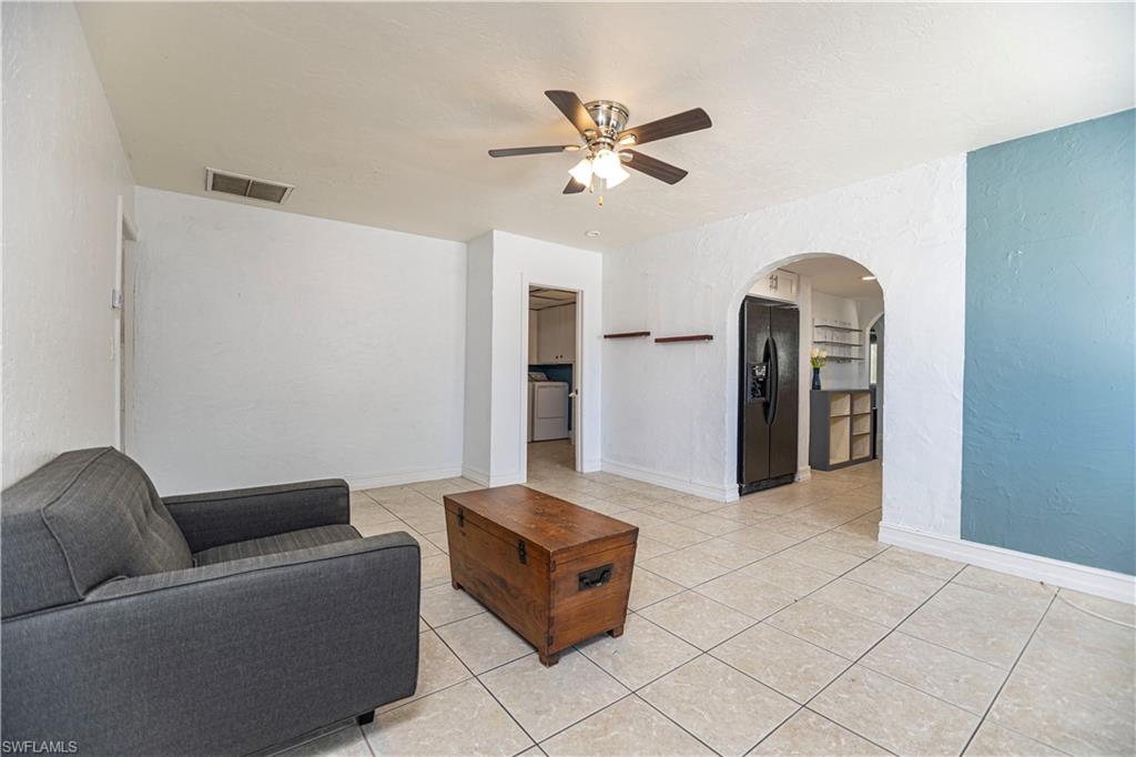 1003 Trail Terrace Drive Naples, FL 34103 - Photo 9 of 23 a living room with furniture and a chandelier
