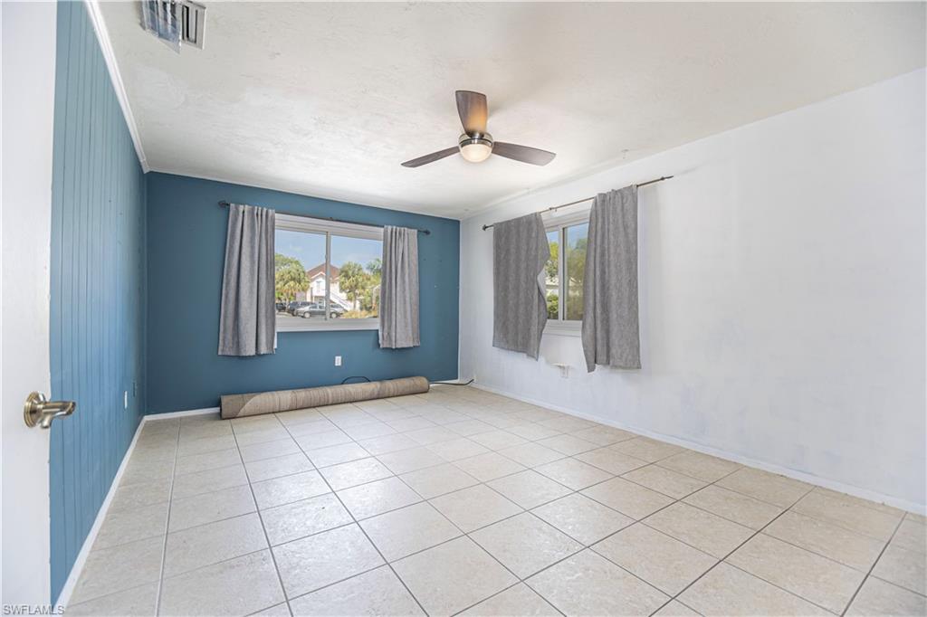 1003 Trail Terrace Drive Naples, FL 34103 - Photo 10 of 23 wooden floor in an empty room with a window