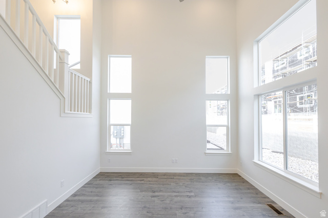 4769 Olive Avenue, Unit 411 Mapleton, UT 84664 - Photo 7 of 19 Empty room with a high ceiling, wood finished floors, and plenty of natural light