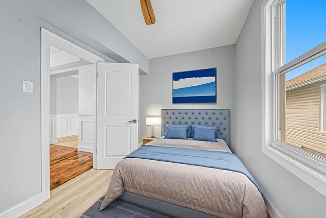 a bedroom with a bed and a window