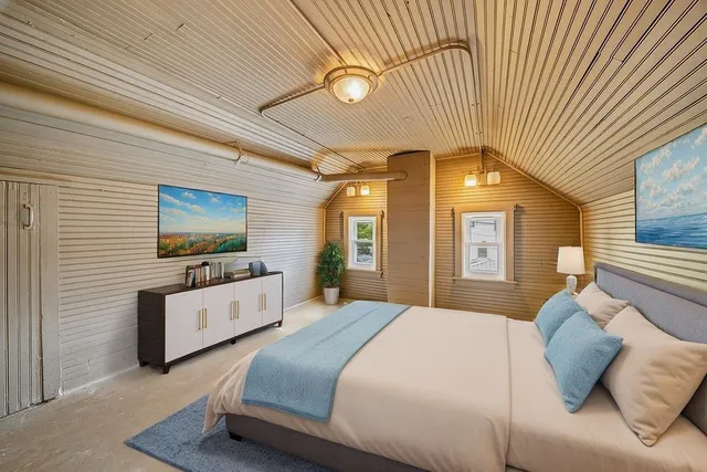 a bedroom with a bed and a flat screen tv