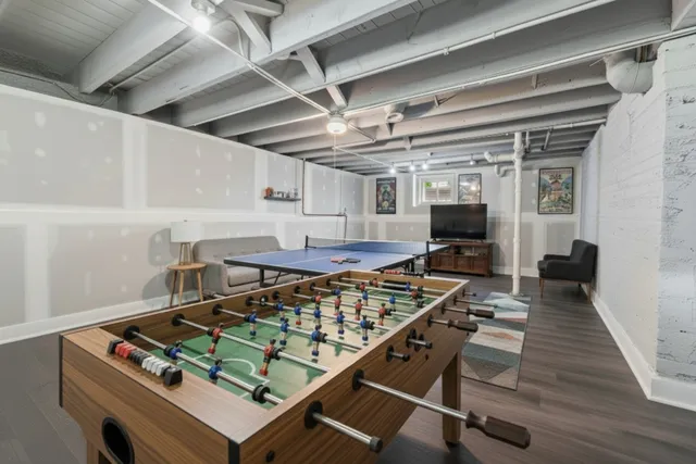 a kitchen with a stove and a wooden floor