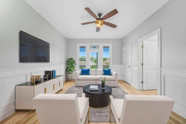 a living room with furniture and a flat screen tv