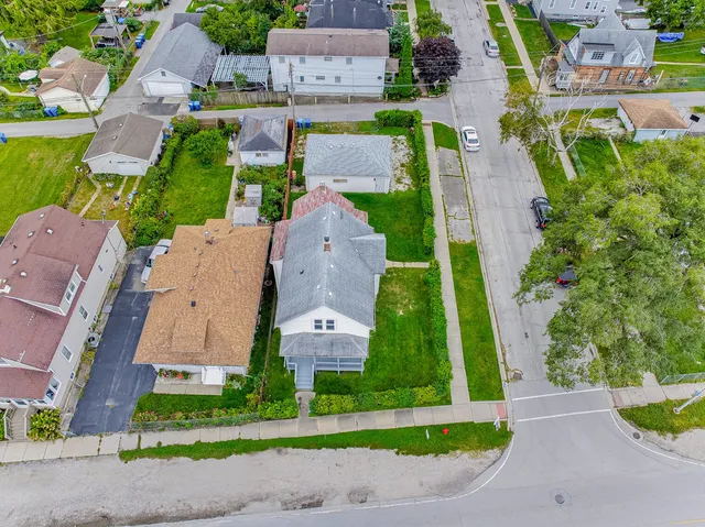 an aerial view of multiple houses with yard