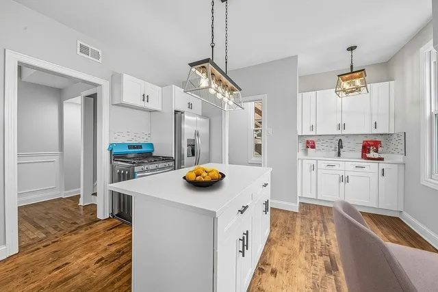 a kitchen with stainless steel appliances granite countertop a sink and a refrigerator