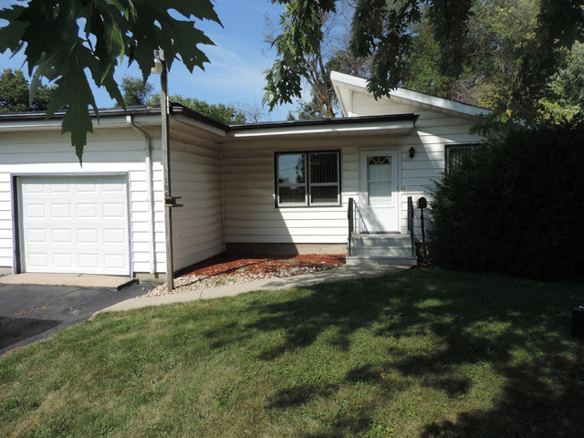 106 Thornton Street Lockport, IL 60441 - Photo 1 of 9 a front view of a house with a yard