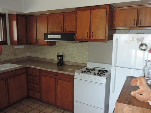 106 Thornton Street Lockport, IL 60441 - Photo 4 of 9 a kitchen with stainless steel appliances granite countertop a sink stove and microwave